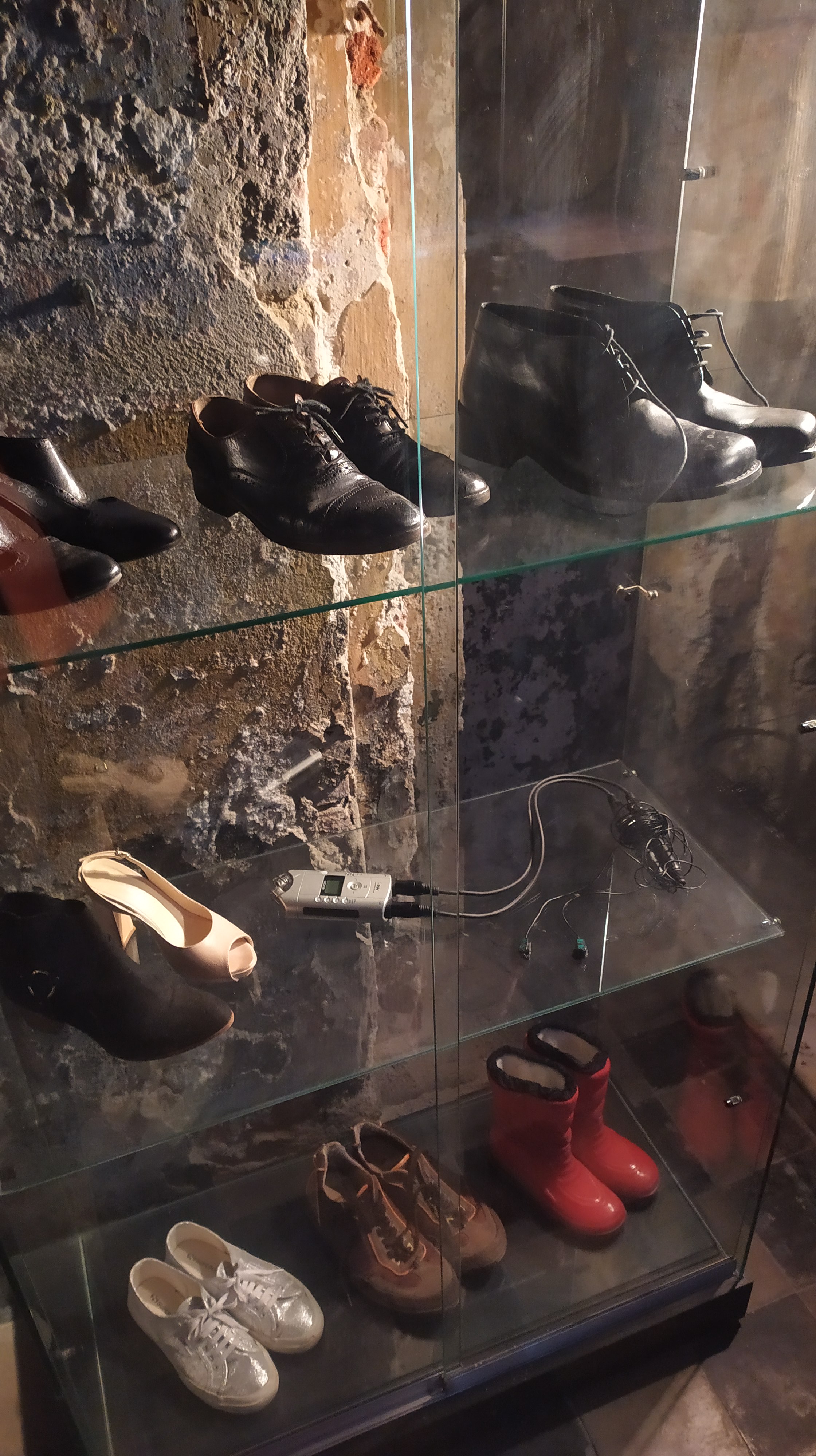 Glass display with different shoes and a handy recorder.